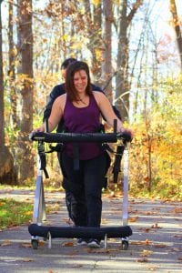woman walks outdoors with the Gait Harness System