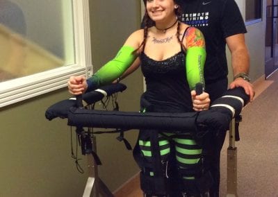 SCI survivor using the Gait Harness System with therapist