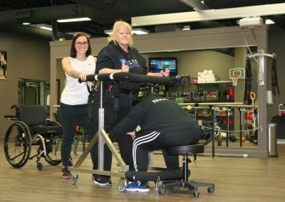 Woman with therapists using the Gait Harness System