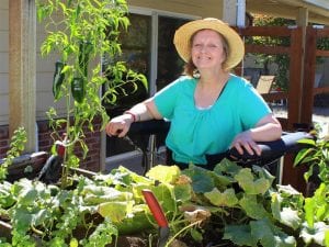 Woman using Gait Harness System outdoors in garden